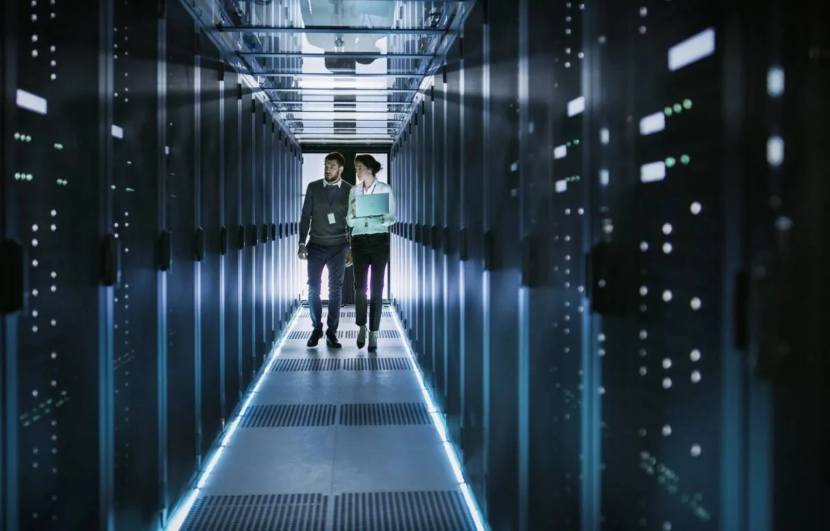 Two IT consultants walking through a data centre