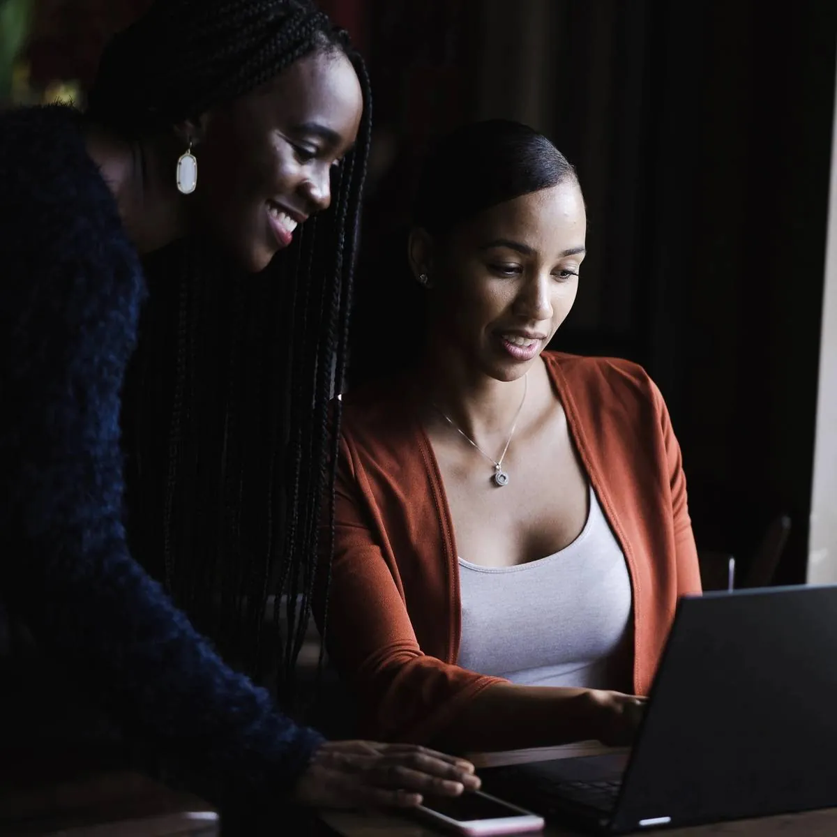 Two colleagues working together on a laptop